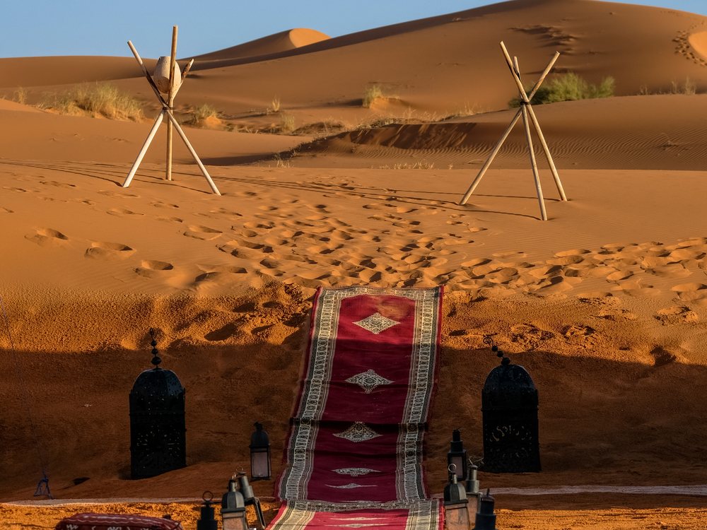 Entrance to the tented camp with rugs and lanterns